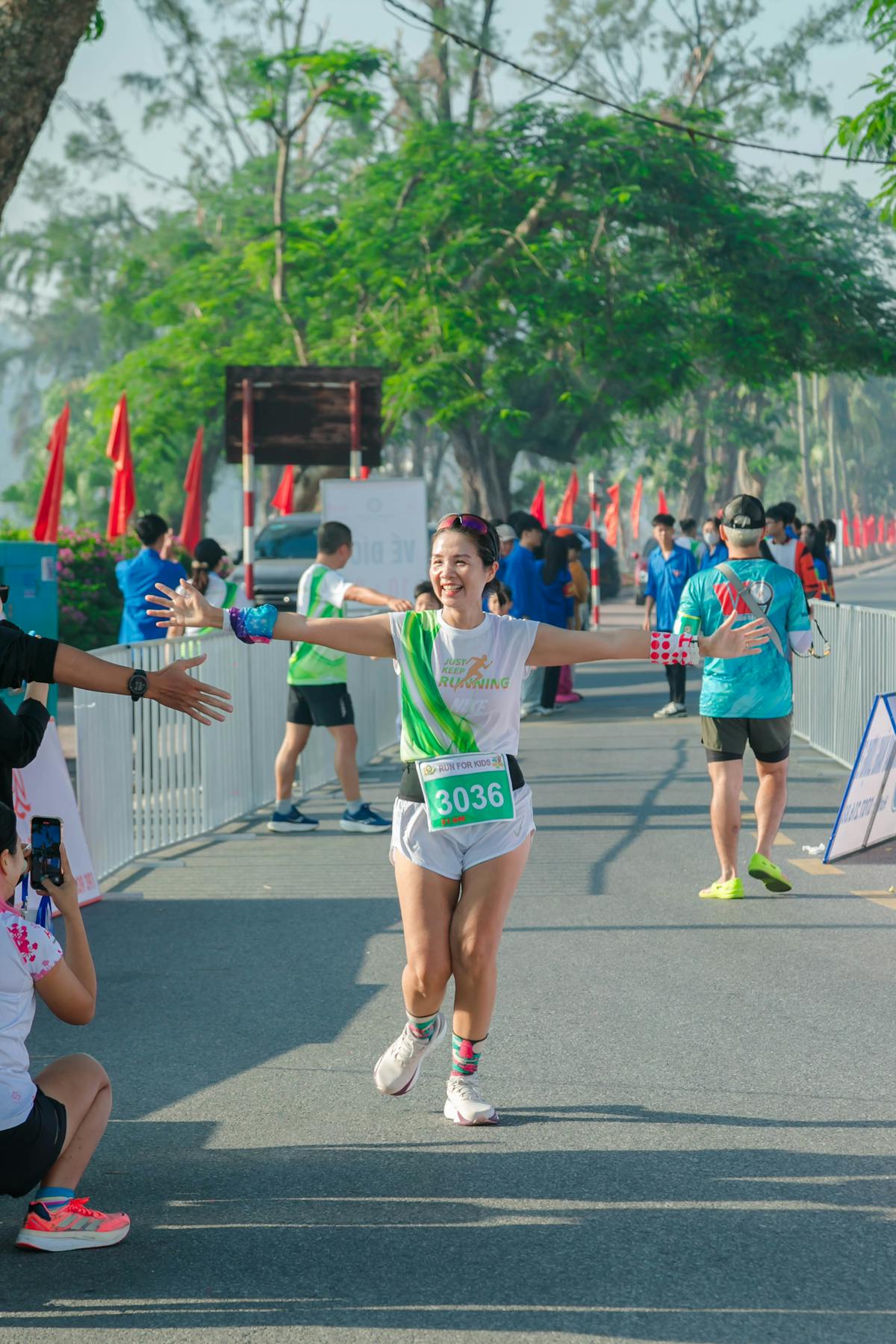 free-photo-of-female-marathon-runner-celebrates-finish-in-vi-t-nam